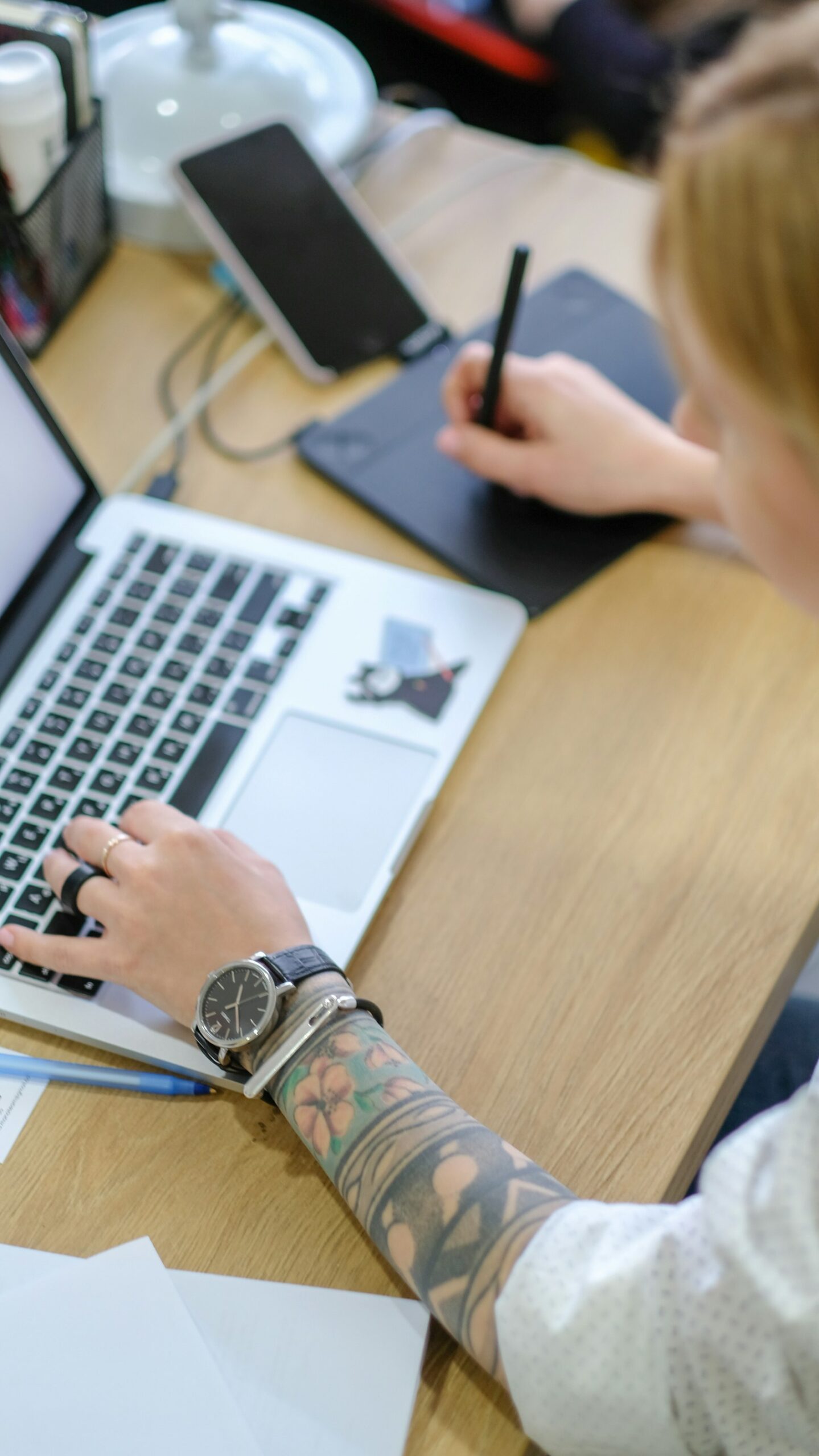 Designer working on a MacBook at a creative agency