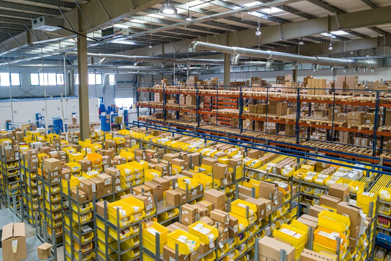 Busy distribution warehouse floor with racking and packages