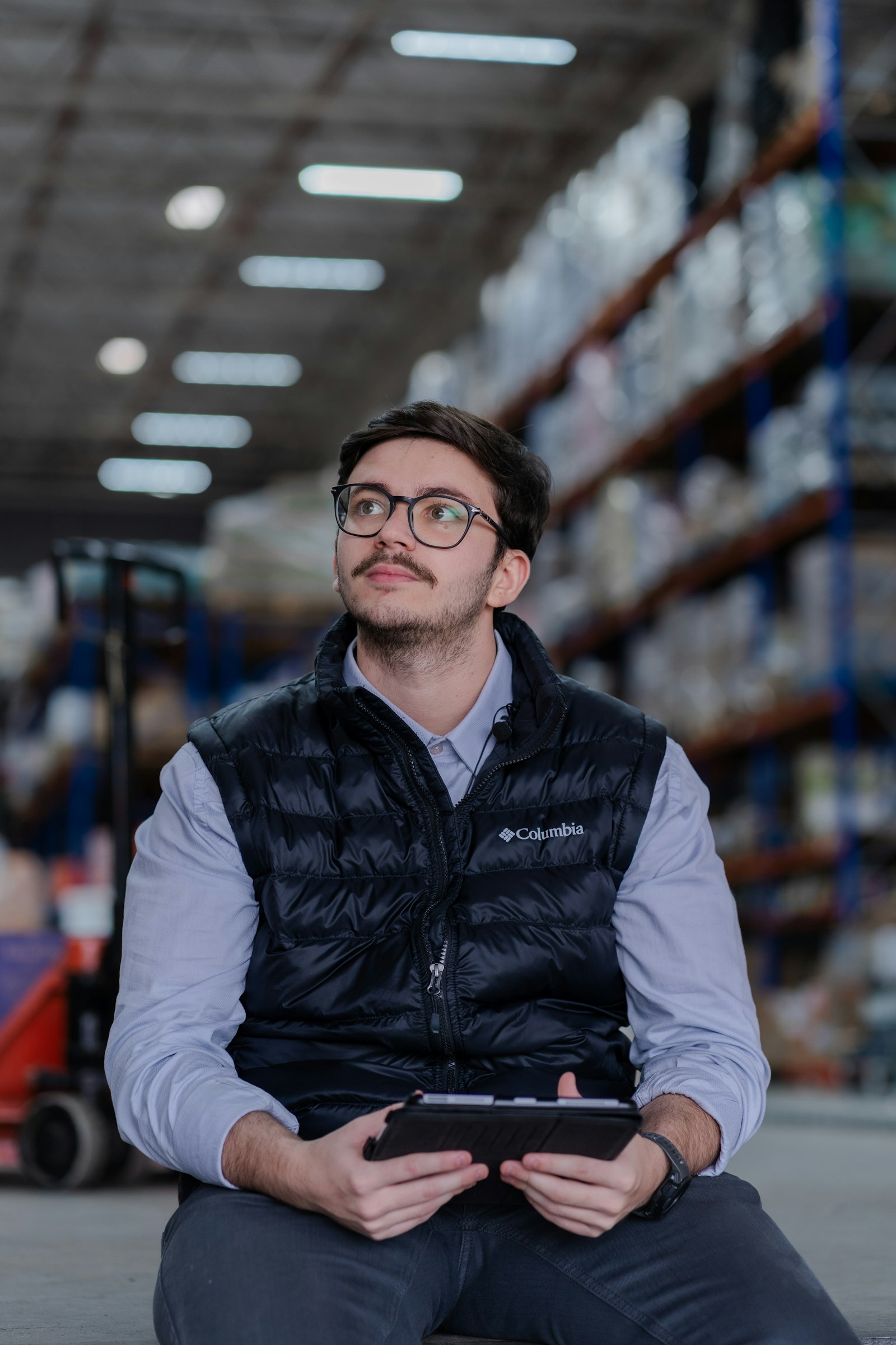 Warehouse manager reviewing operations on a tablet