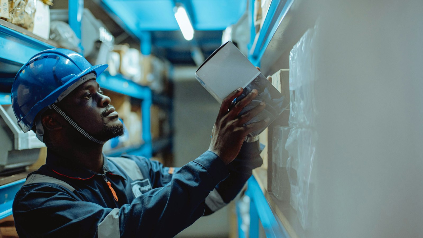 Warehouse worker checking a shipping label in a distribution center