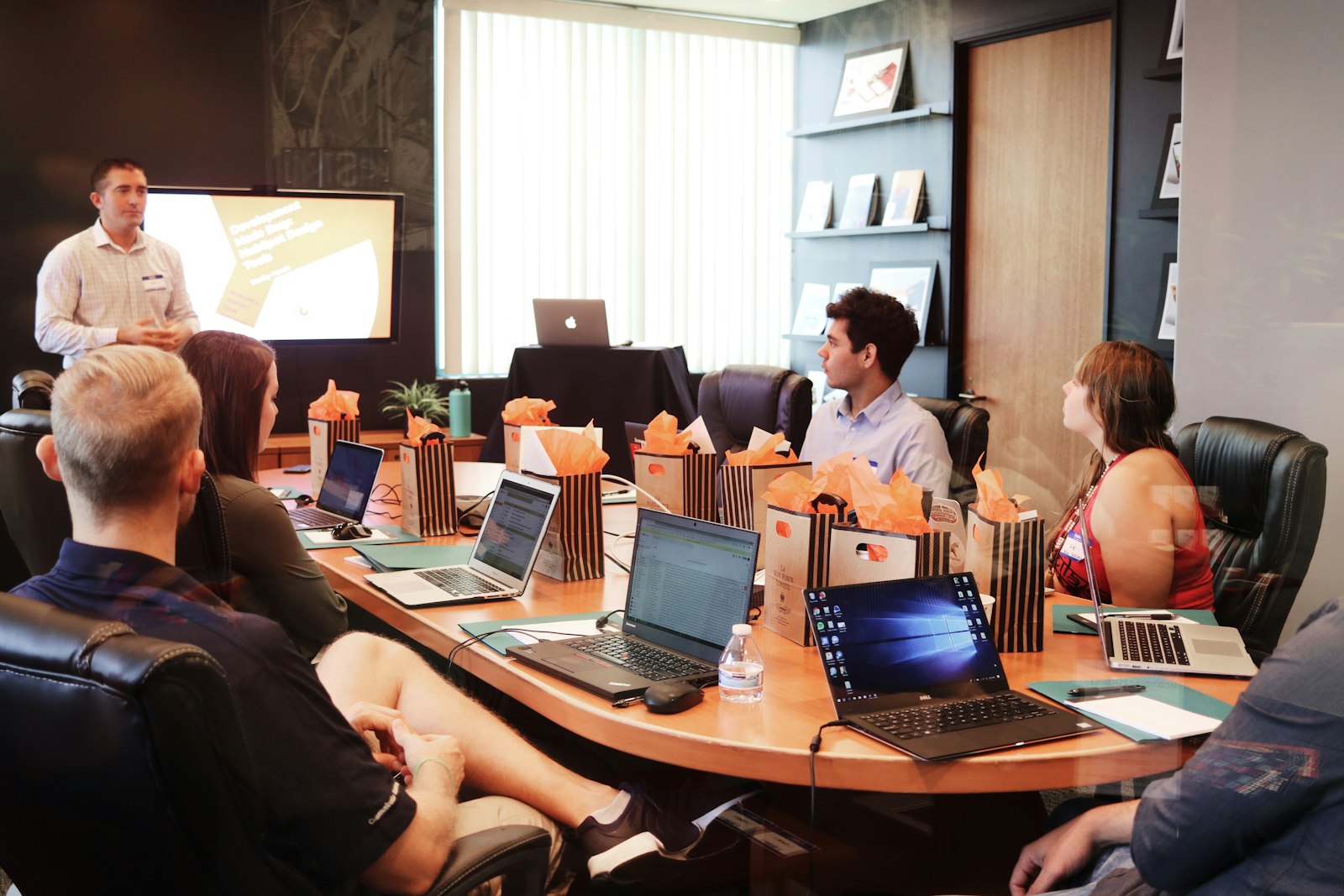 Consultant presenting to a professional services team in a conference room